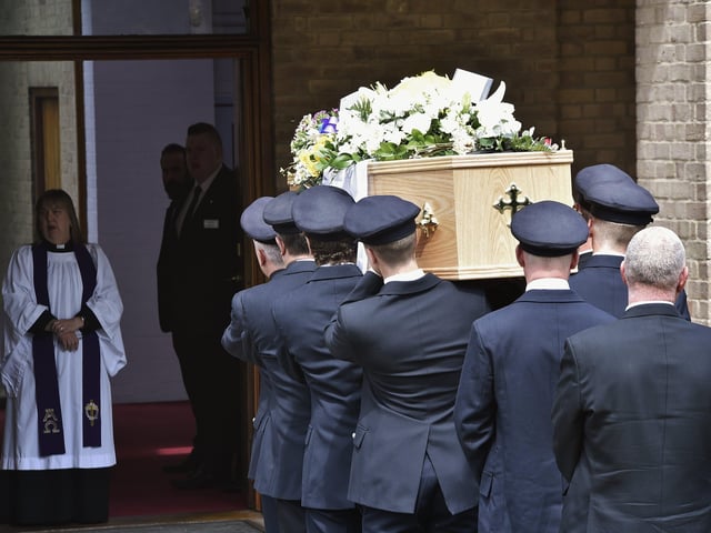 Mourners attend the funeral of Will Baker