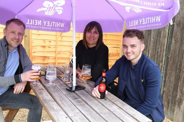 Joshua Beck enjoys his first official pint with dad Karl and mum Faye