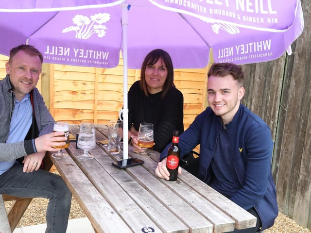 Joshua Beck enjoys his first official pint with dad Karl and mum Faye