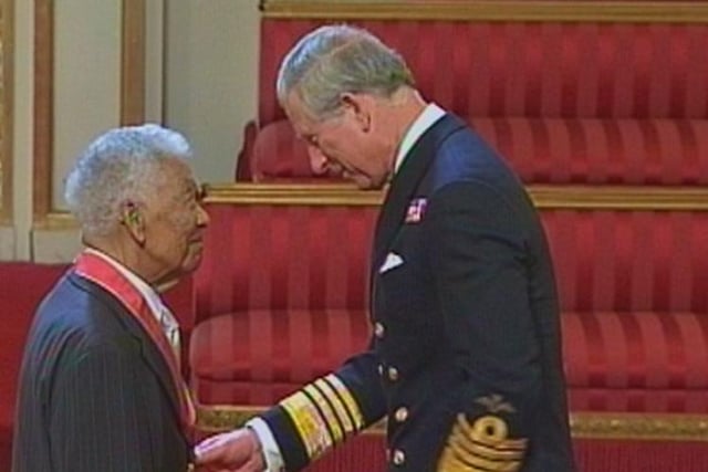 Earl Cameron is invested as a CBE by Prince Charles.