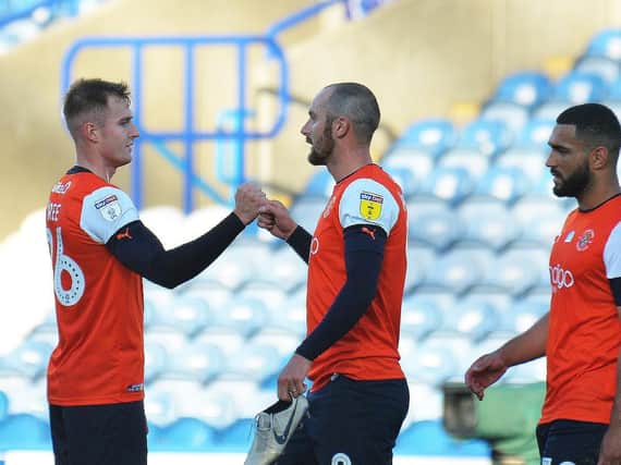 Luton celebrate a crucial 2-0 win at Huddersfield on Friday night