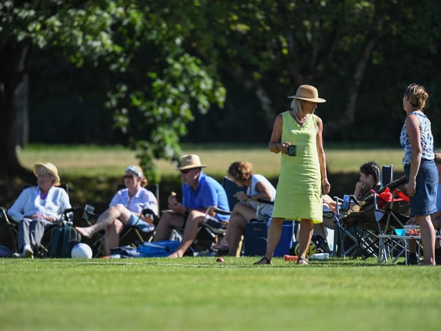 Watching cricket in the sun. West Chiltington v Burgess Hill. Picture by PW Sporting Photography
