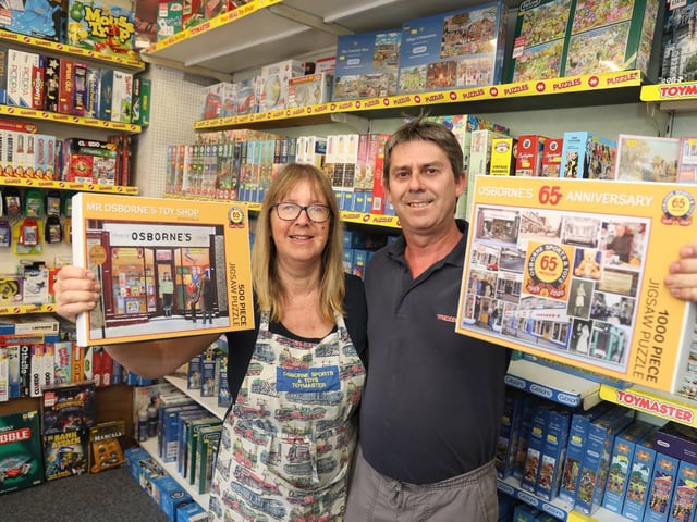 Libby Risdale and Will Osborne with the limited edition jigsaws of the shop front and a montage of photos