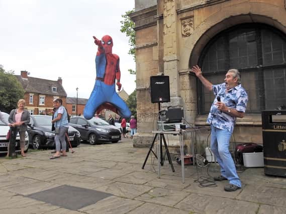 Spiderman makes an appearance while Barry Hale performs during the fundraising event for Wicksteed Park in Rothwell on Saturday. Photo by Andrew Carpenter