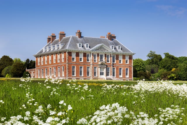 South front of the house from the meadow with white flowers at Uppark House and Garden, West Sussex. Picture:National Trust/Andrew Butler