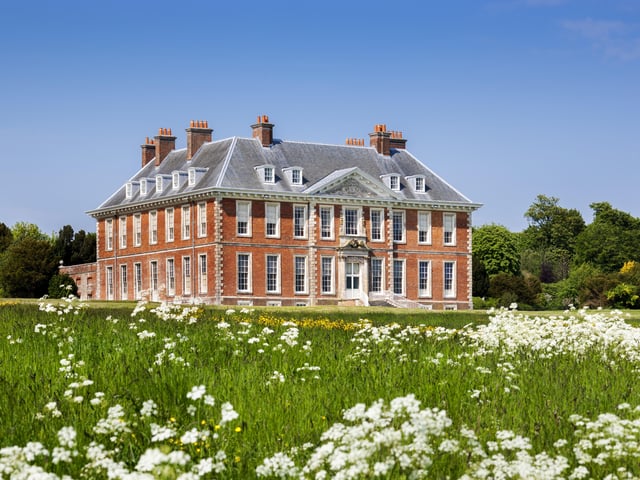 South front of the house from the meadow with white flowers at Uppark House and Garden, West Sussex. Picture:National Trust/Andrew Butler