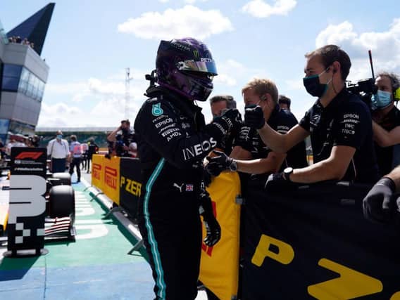 Lewis Hamilton celebrates with his Mercedes team after clinching pole position for Sunday's British GP at Silverstone. Photo: Getty Images