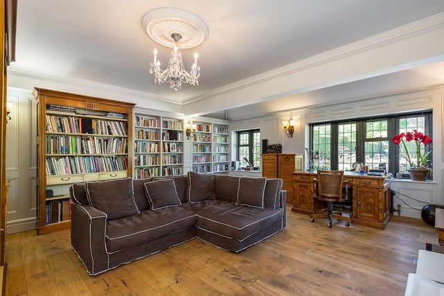 The charming sitting room has beautifully fitted joinery, providing book shelving.