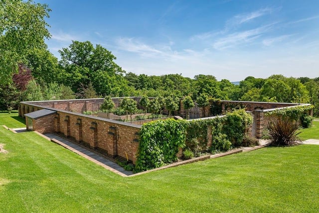 Walled garden with well stocked beds and advanced irrigation system. To the northern wall are two bespoke greenhouses.