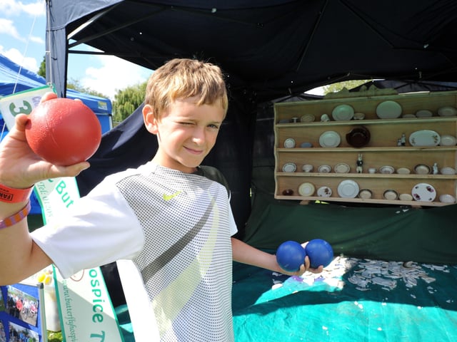 Sam Holland, 11, takes aim on the crockery smashing stall to raise funds for the Butterfly Hospice Trust.