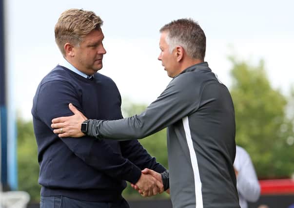 Posh boss Darren Ferguson (right) and Oxford United manager Karl Robinson will be pushing for promotion this season.