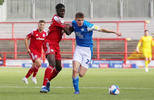 Ethan Hamilton of Peterborough United in action with Tariq Uwakwe of Accrington Stanley. Photo: Joe Dent/theposh.com.