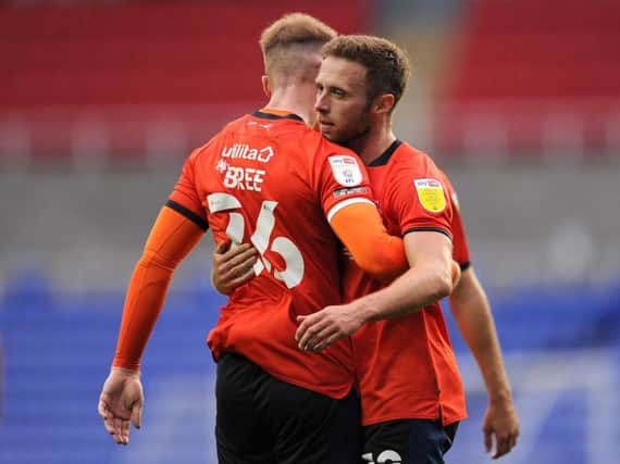 Jordan Clark gets a hug from team-mate James Bree after scoring the only goal of the game