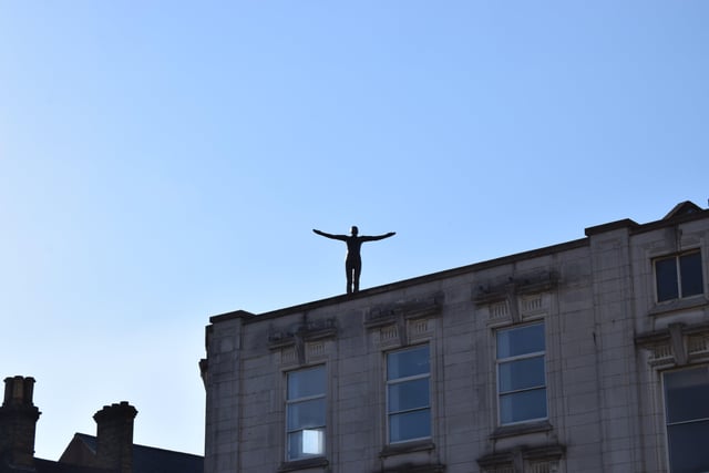 Antony Gormley’s ‘Places To Be’ were restored and placed on three roofs in the city centre