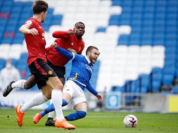 Brighton's Aaron Connolly is hauled down by Manchester United's Paul Pogba