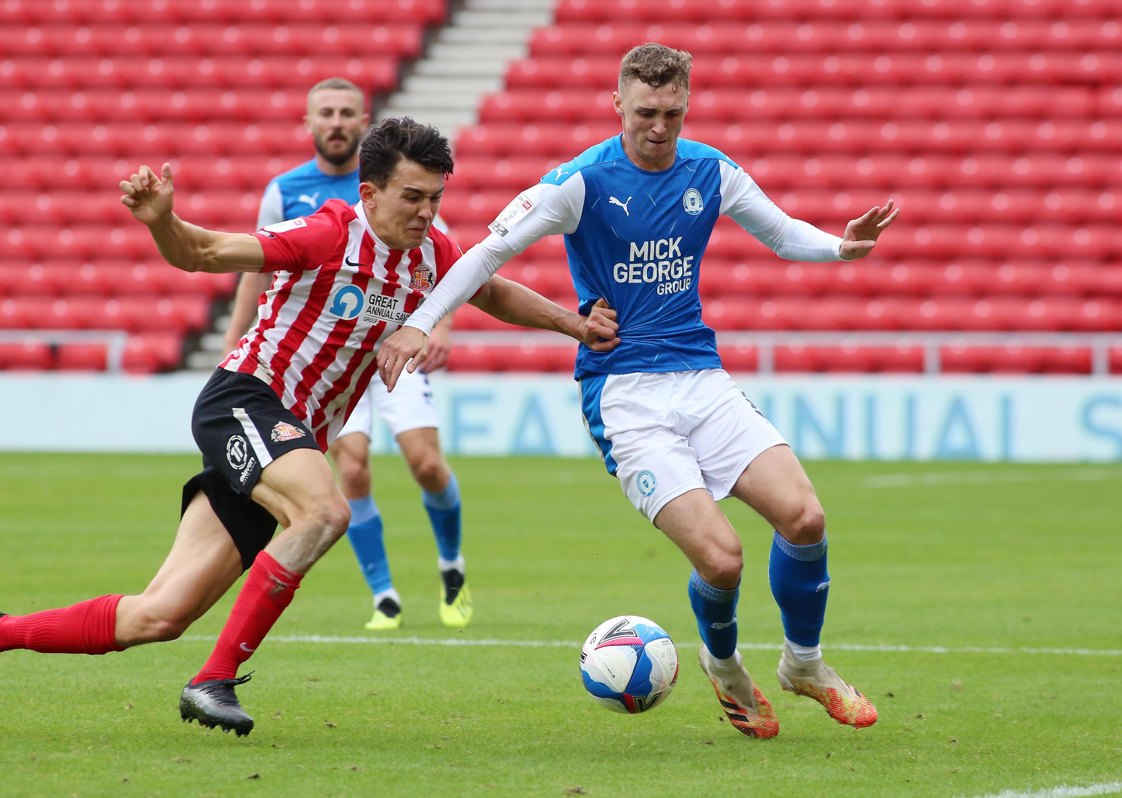Jack Taylor of Peterborough United in action with Luke O'Nein of Sunderland. Photo: Joe Dent/theposh.com.