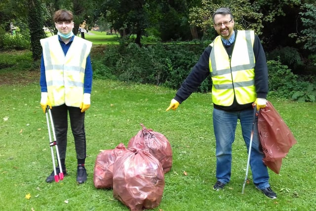 Some of the volunteers highlighting the amount of rubbish collected during the litter pick