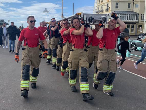 Firefighters walk from Shoreham fire station to Brighton Palace Pier to raise money for Debby Sadler who was diagnosed with pancreatic cancer. Picture: Dave Mayfield SUS-200210-155401001