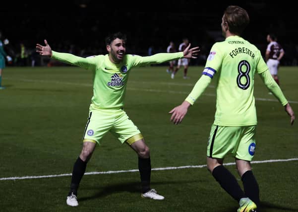 Michael Smith (left) congratulates Chris Forrester on his dramatic late winning goal for Posh at Northampton in 2016. Photo: Joe Dent/theposh.com.