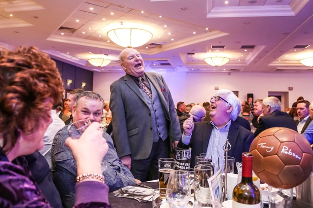 Tommy roars with laughter at his fund-raising night.