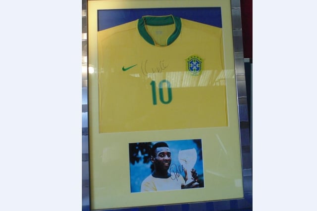 NoSigned Pele shirt and signed Pele photograph in framed mount. Estimate £200-£400