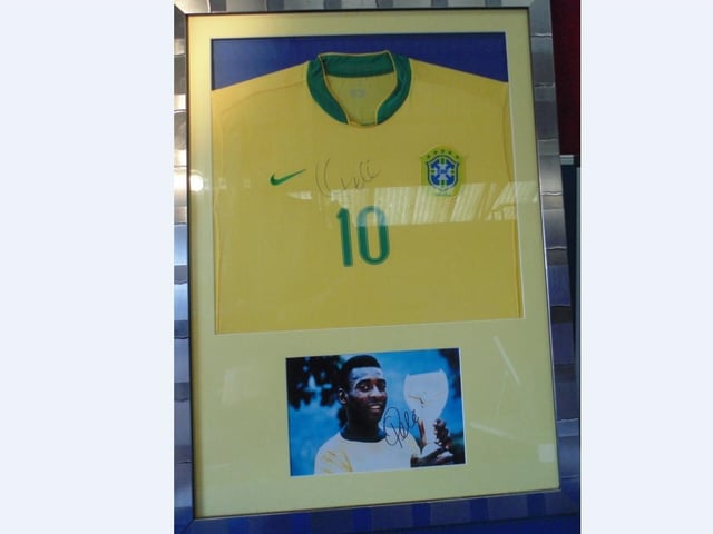 NoSigned Pele shirt and signed Pele photograph in framed mount. Estimate £200-£400