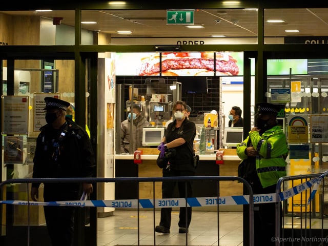 Police taped off an area outside the McDonald's restaurant in the Drapery