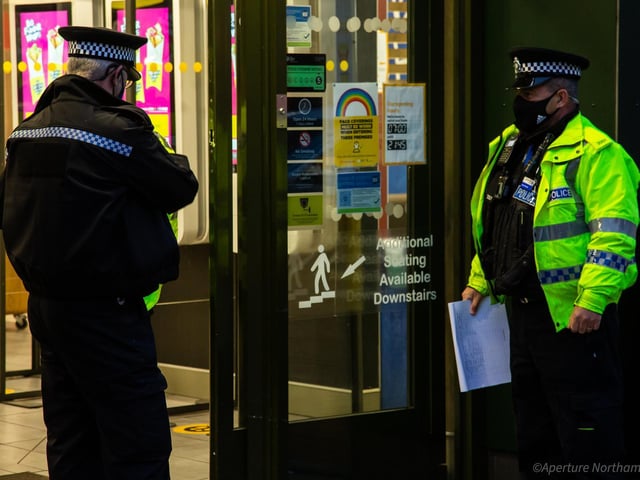 Police officers inside the restaurant doors