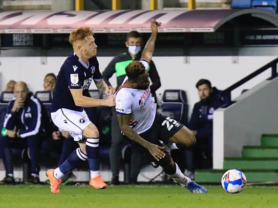 Kazenga LuaLua is pulled to the ground during last night's 2-0 defeat at Millwall