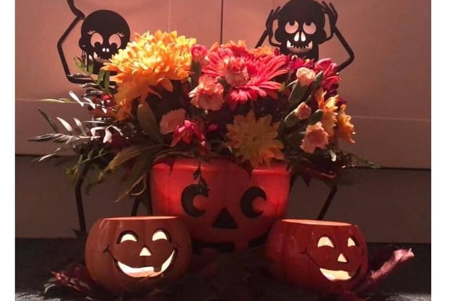 Ria, who is a member of west Herts Flower Club, made a flower arrangement for Halloween as part of challenge for October. She decided to make it spooky with lights and a witch