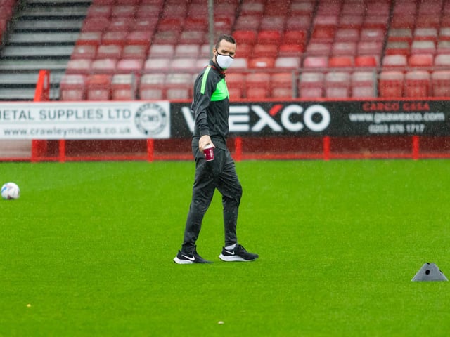 Officials inspect the pitch before the game
