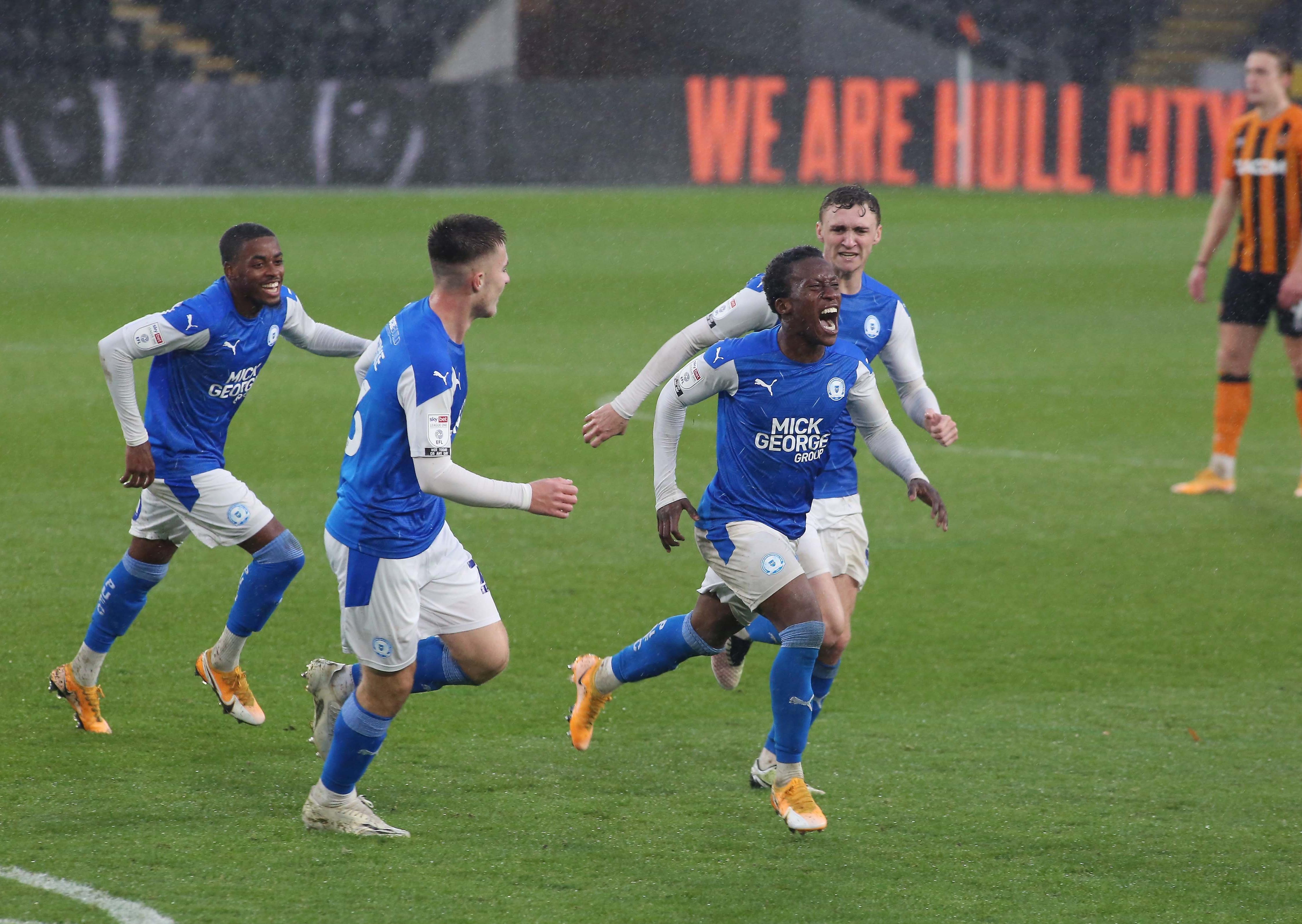 Siriki Dembele keads the player celebrations after scoring for Posh at Hull. Photo: Joe Dent/theposh.com.