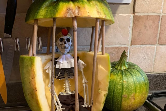 A rather unique take on traditional pumpkin carving - even the skeleton looks pleased with his prison.