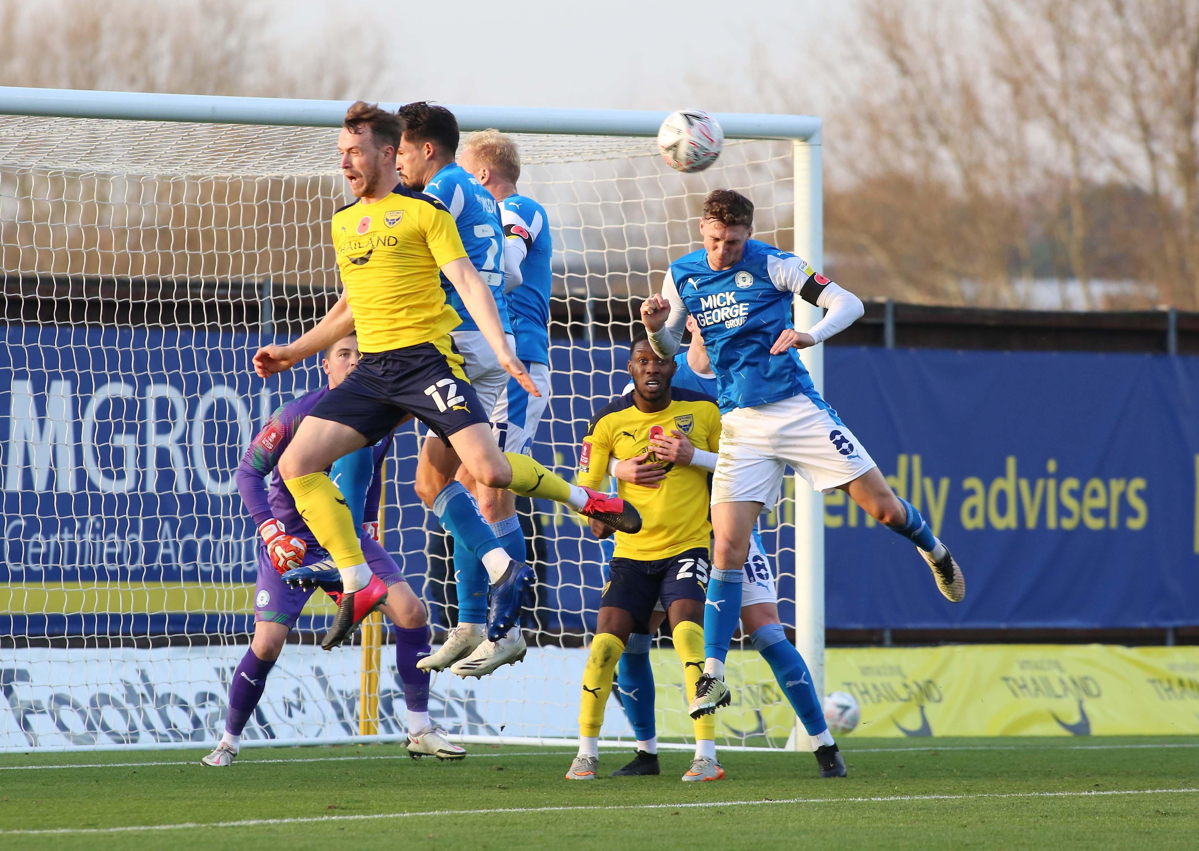 Jack Taylor of Peterborough United heads the ball clear from an Oxford United corner. Photo: Joe Dent/theposh.com.