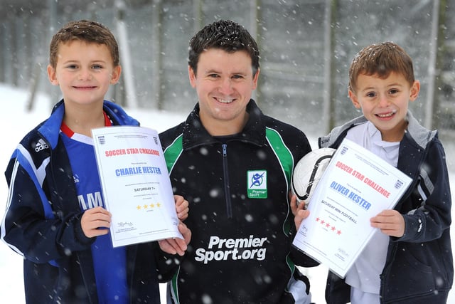 Snow hit Burgess Hill on Saturday 18th Dec. Area Co-ordinator Peter Mullane of Premier Sport still managed to run the footballing tuition at St Pauls College. Pictured here with Charlie and Oliver Hester receiving their football skills awards ENGSNL00120101220104545