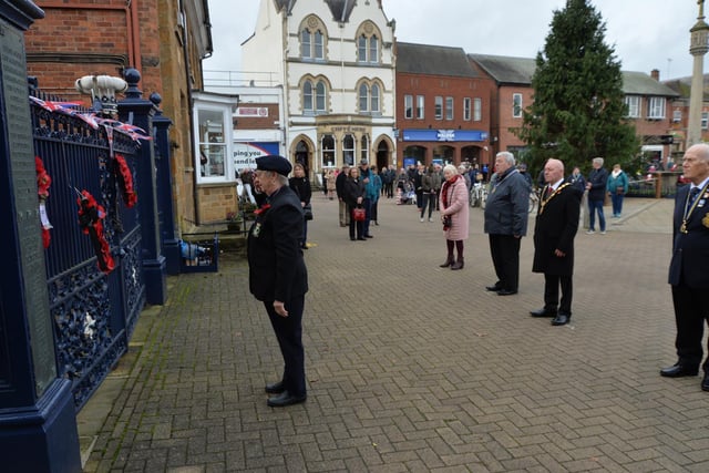 Pat Middleton of the Royal Naval Associaion lays a wreath on the memorial gates.