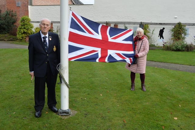 Rev John Morley and Jill Mann vice chairman raise the new union Jack before the 11.11.11 service on the Square.