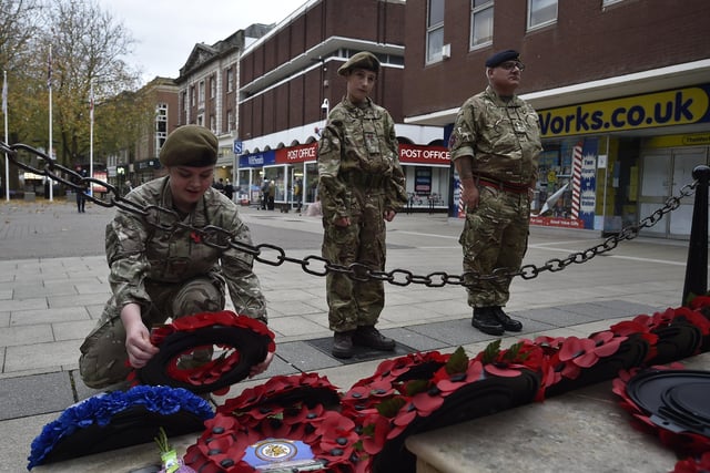 Nenegate School army cadets Caitlin Ramm and Kyle Thompson-Parkinson with Lt Jon Blundell laying a wreath at the War Memorial at Bridge Street, Peterborough  on Armistice Day. EMN-201111-153046009