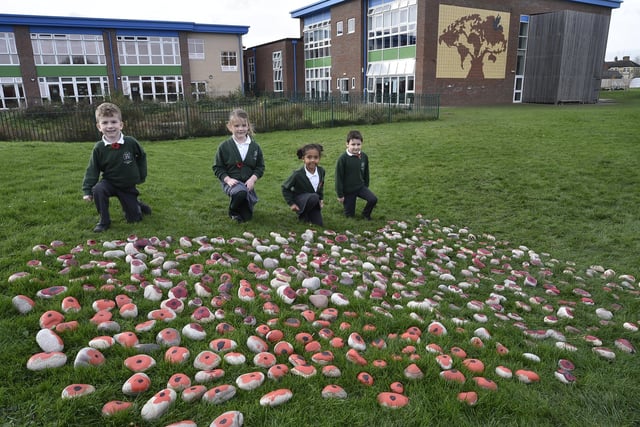 Pupils from Woodston primary school have painted and laid over 500 stones placed in the school grounds on Armistice Day. EMN-201111-131334009