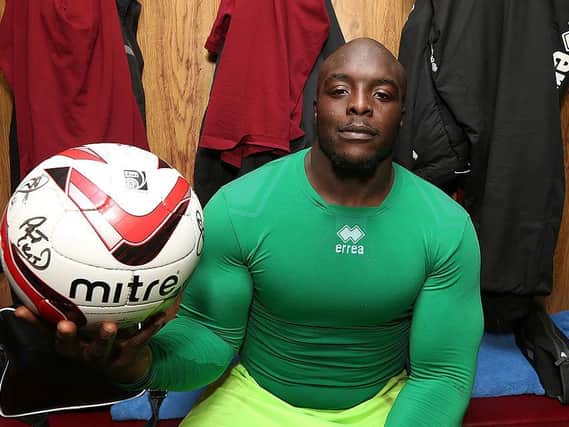 Adebayo Akinfenwa shows off the signed match ball following the Cobblers' 4-2 win at Accrington in November, 2012