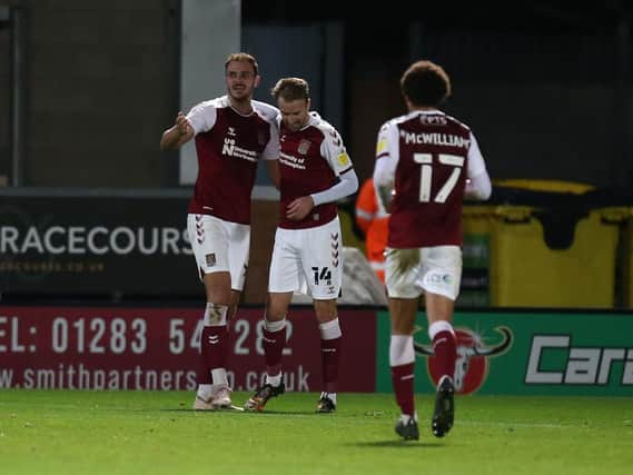 ALL SMILES: Chris Lines and Harry Smith celebrate after Cobblers made it 3-0 at Burton Albion on Saturday. Pictures: Pete Norton