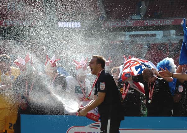 Charlie Lee leads the celebrations after Posh beat Huddersfield 3-0 in the 2011 League One play-off final at Old Trafford.