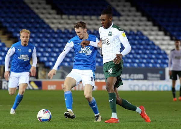 Jack Taylor of Peterborough United in action with Jerome Opoku of Plymouth Argyle. Photo: Joe Dent/theposh.com.