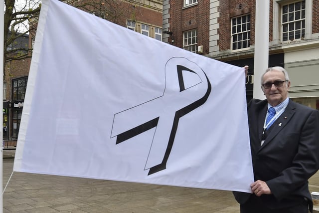 Cllr John Holdich raising the White Ribbon flag outside the Town Hall EMN-201125-104410009