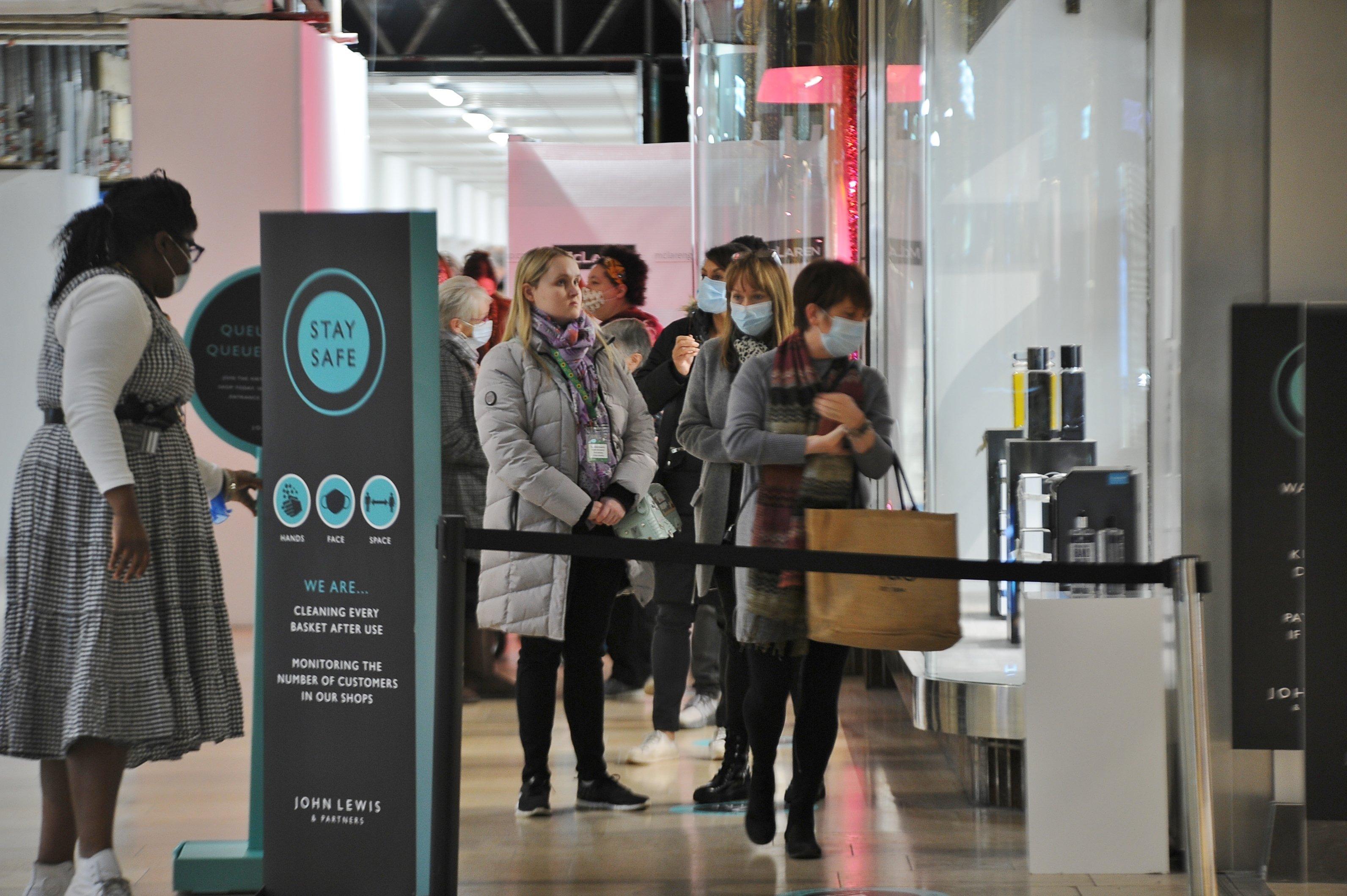Post lockdown shoppers in the city   Queensgate shopping centre. Shoppers queueing outside John Lewis EMN-200212-094137009