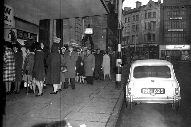 Shoppers queue up around the block on the Drapery for the New Year Day sales on January 1, 1965.