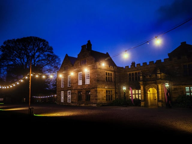 Stunning Christmas lights illuminate the historic abbey at night time.