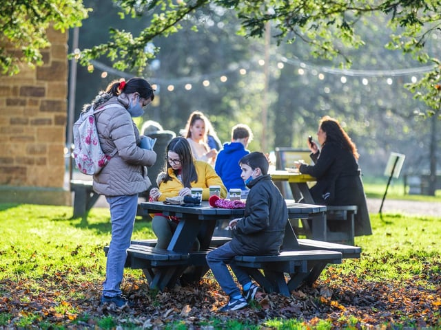Customers of the new deli, 'Common Ground', enjoying their coffees-to-go on the abbey's grounds.