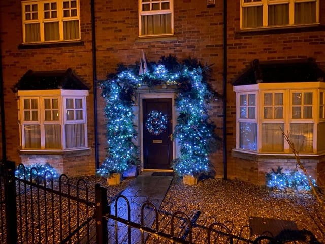 I absolutely love the wreath complements the Christmas garland all around the door.