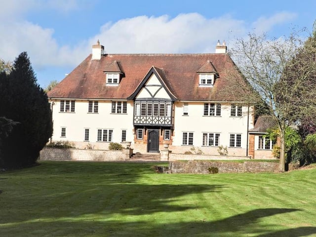 This eight-bedroom country house in Towcester has an adjoining annexe, separate detached cottage, outbuildings and paddocks as well as a swimming pool and tennis court! It is set in 10.5 acres.
